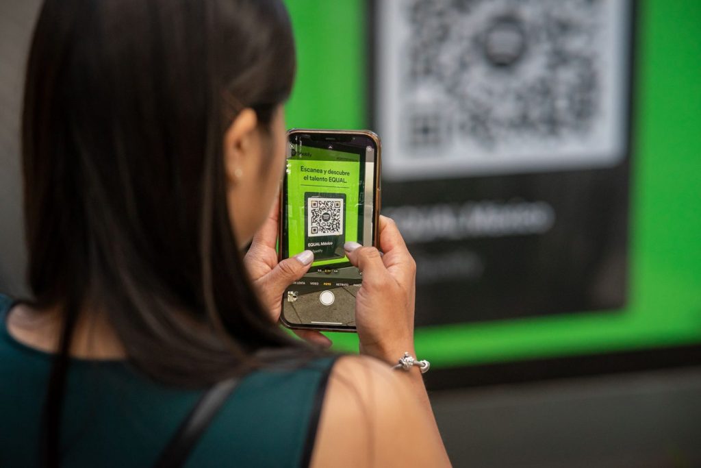 Une adhérente scanne un QR code avec son smartphone à l’entrée
